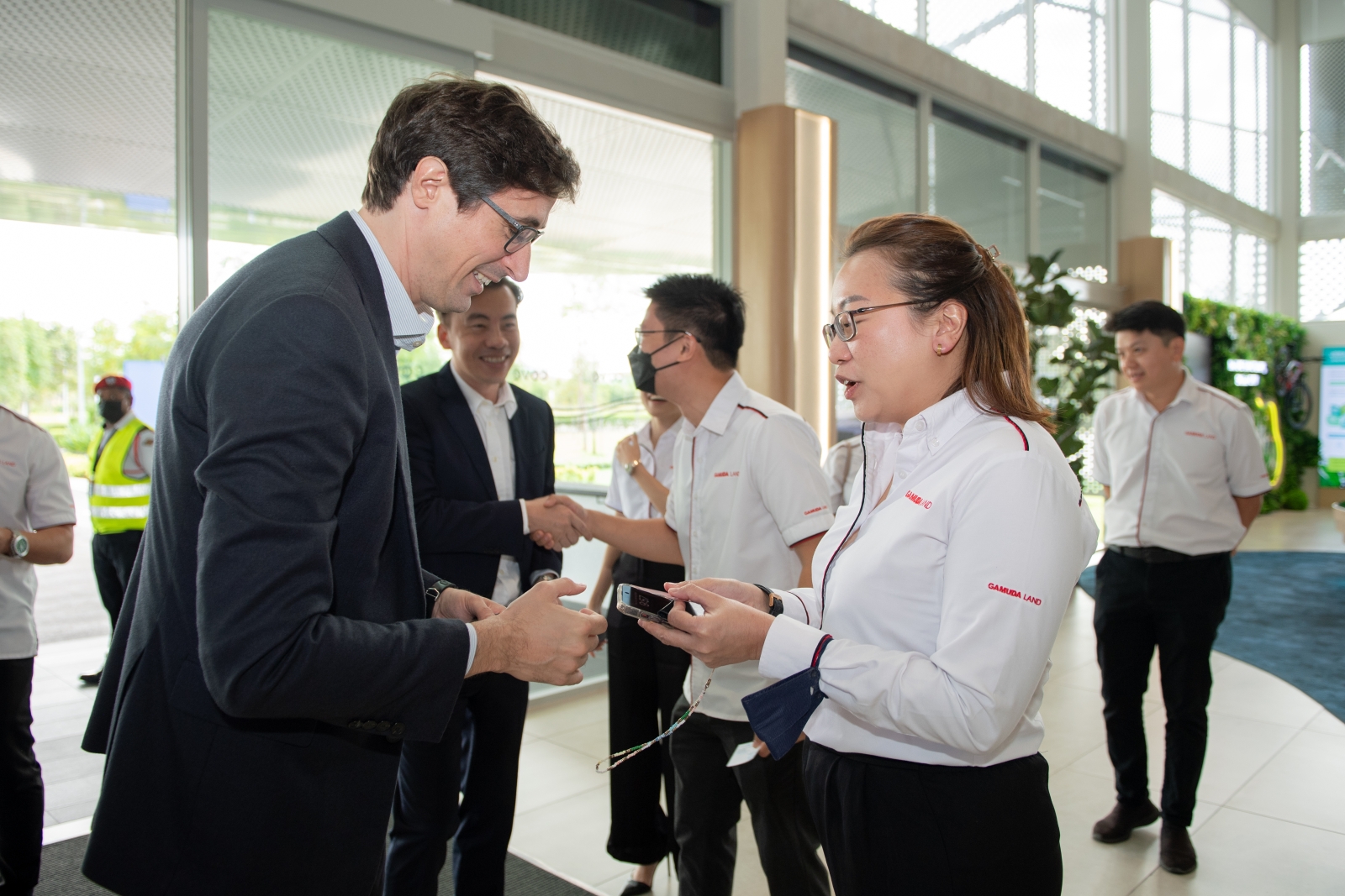 Representatives from ENGIE and Gamuda Land exchange business cards as they meet for MoU signing ceremony.