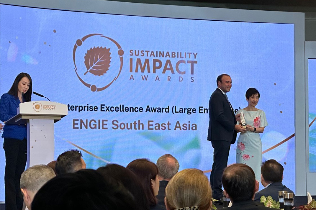 Guillaume Darmayan accepts trophy for Impact Enterprise Excellence at the Sustainability Impact Awards from Minister Grace Fu.