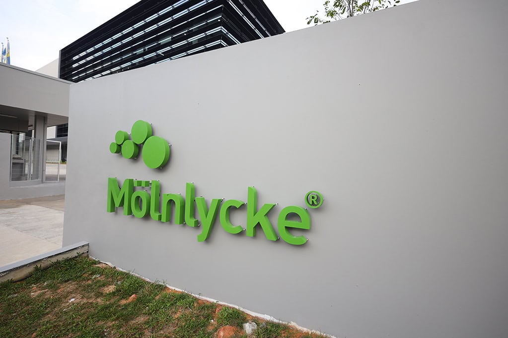 Mölnlycke logo on building exterior, showcasing corporate branding.